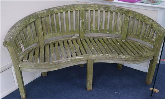 A curved garden bench, W.161cm